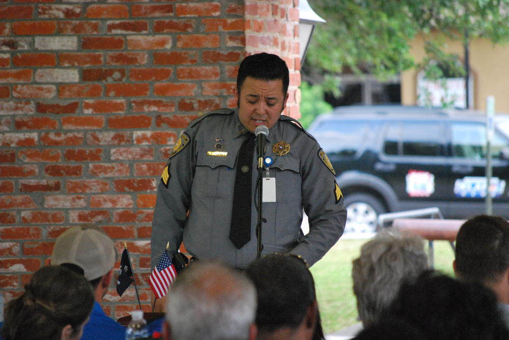Sgt Jose Alexander singing into microphone